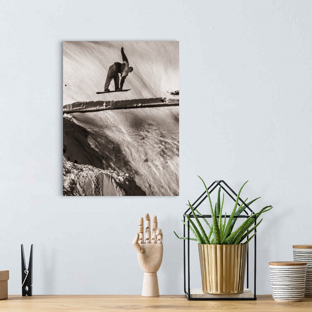 A bohemian room featuring Black and white image of Tracy Latzen grabbing his snowboard in hte air at Donner Summit, Califor...