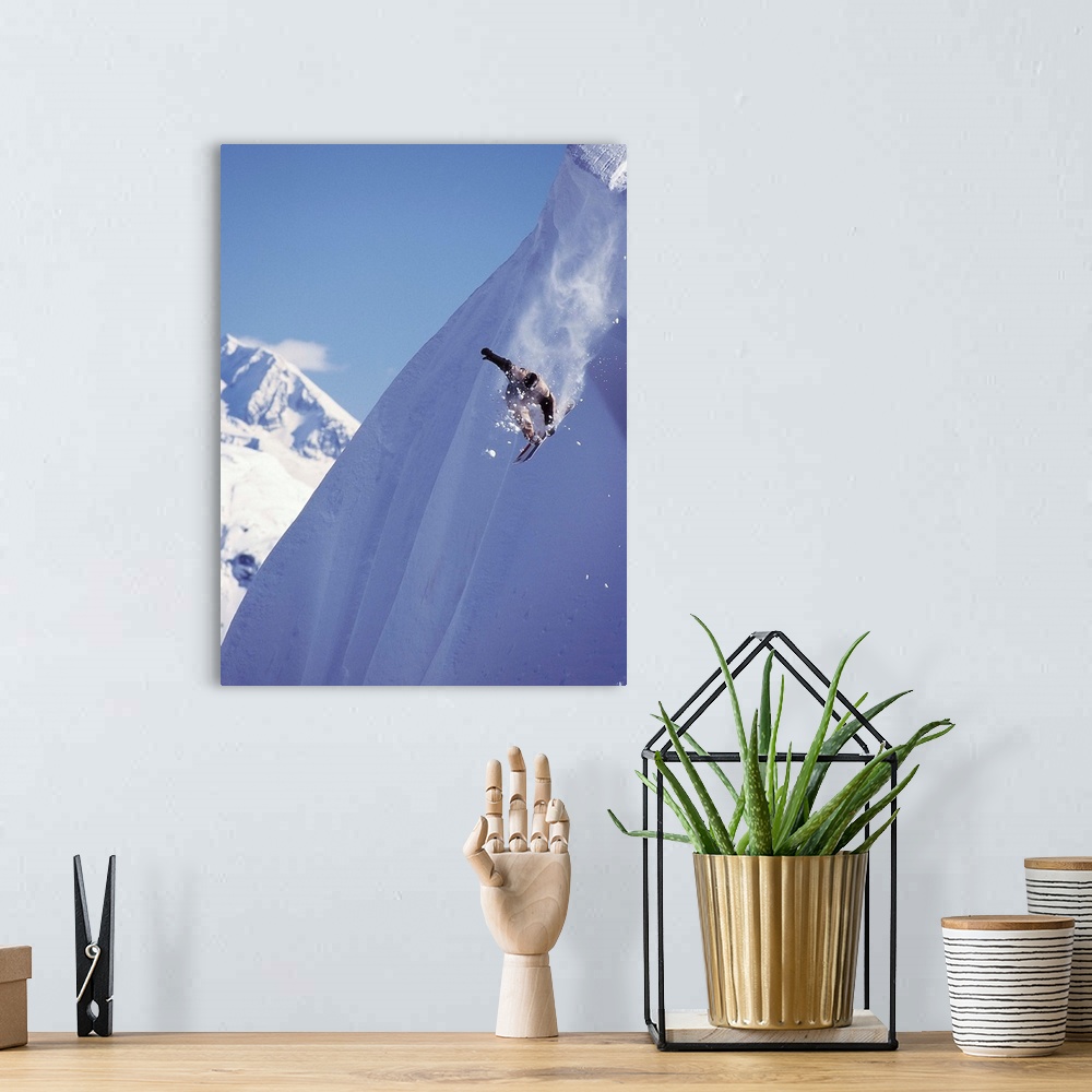 A bohemian room featuring Travis Parker snowboarding down a steep mountainside at Whistler, British Columbia, Canada.