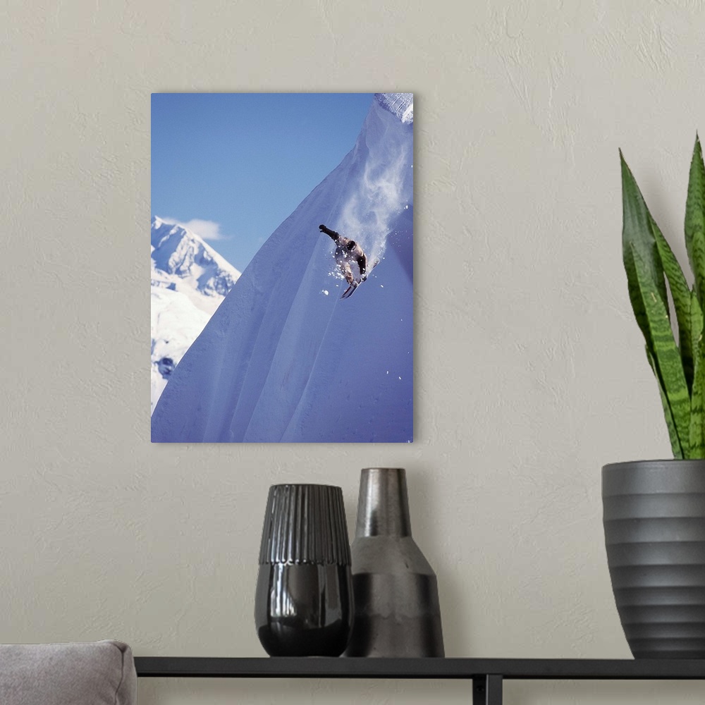 A modern room featuring Travis Parker snowboarding down a steep mountainside at Whistler, British Columbia, Canada.