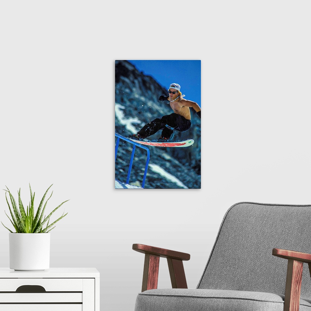 A modern room featuring Vintage photo of Jeff Brushie as he tailslides a rail on the Blackcomb glacier. Photo may have a ...