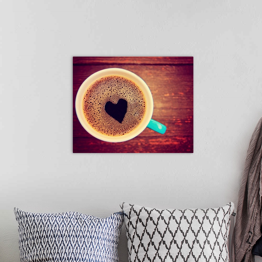 A bohemian room featuring a cup of coffee with a heart shape toned with a retro vintage look