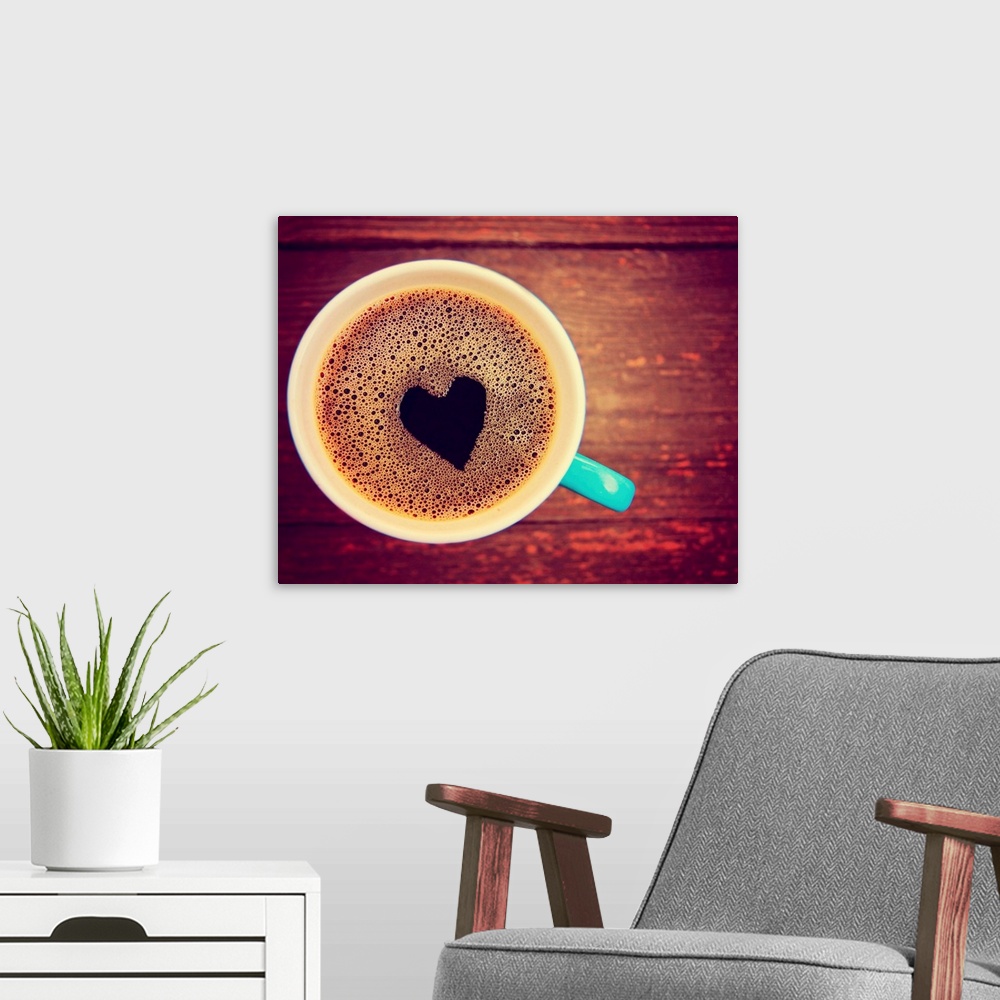 A modern room featuring a cup of coffee with a heart shape toned with a retro vintage look