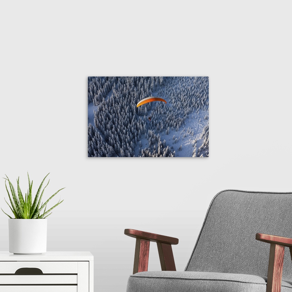 A modern room featuring Aerial View Of Paramotor Flying Over The Forest In Winter, Poland