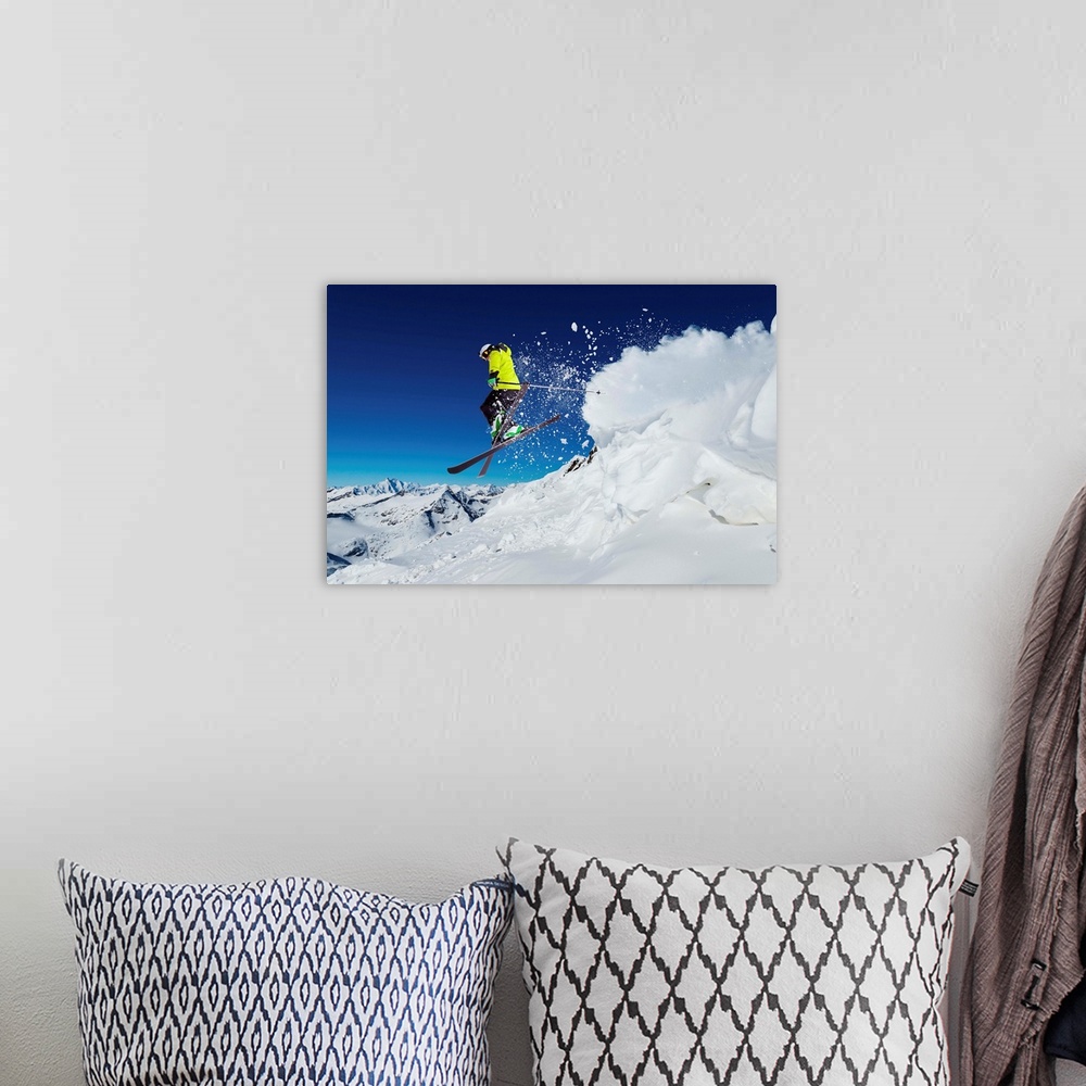 A bohemian room featuring Alpine skier skiing downhill, blue sky in background.