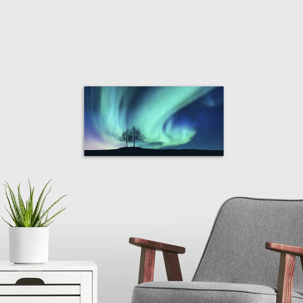 A modern room featuring Aurora Borealis And Silhouette Of Trees On A Hill