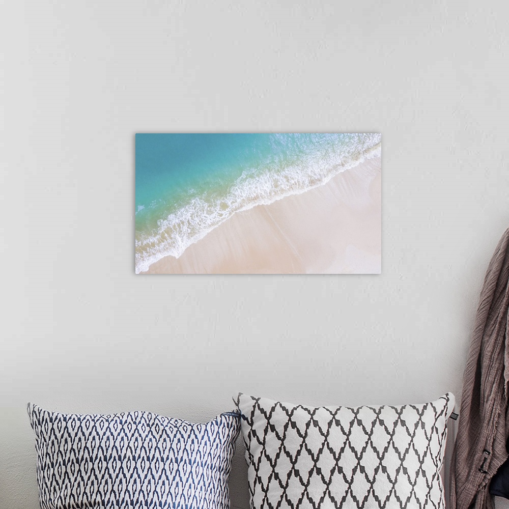 A bohemian room featuring Beach top view or aerial view with shade emerald, blue water and wave foam, soft focus.