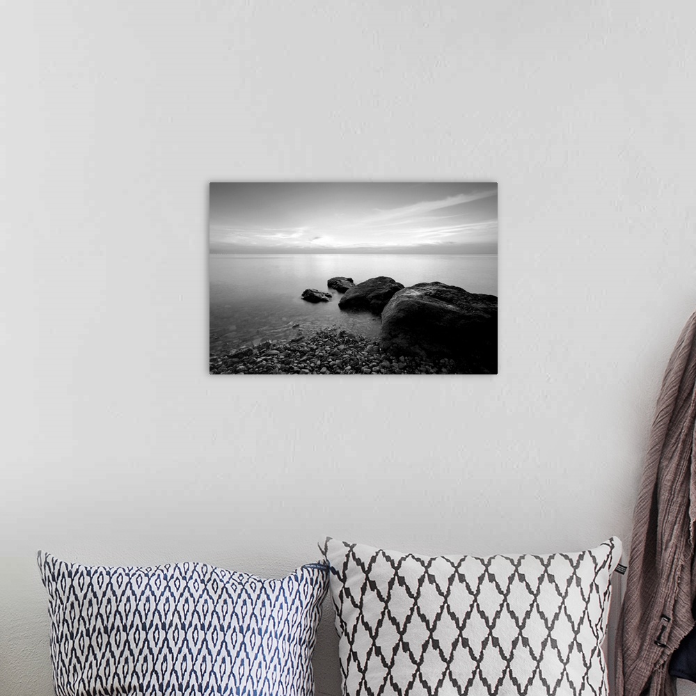 A bohemian room featuring Black and white long exposure photo of beach in the evening.