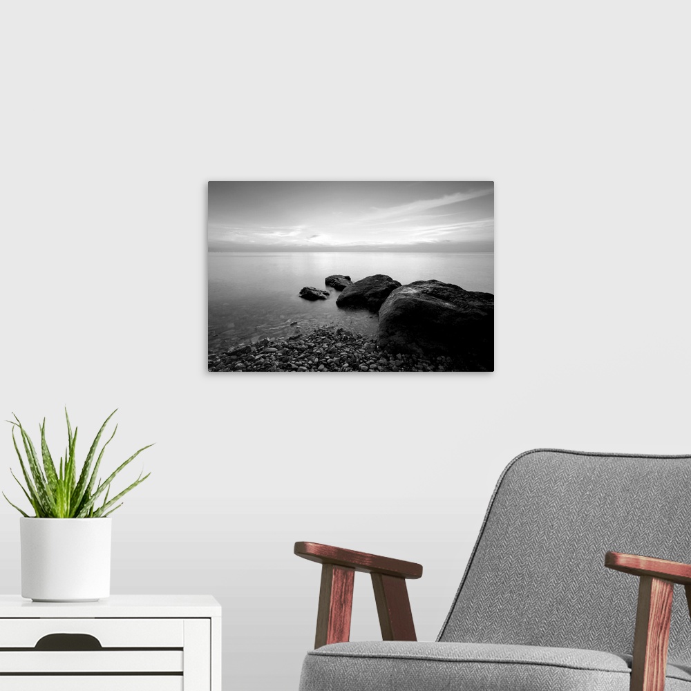 A modern room featuring Black and white long exposure photo of beach in the evening.