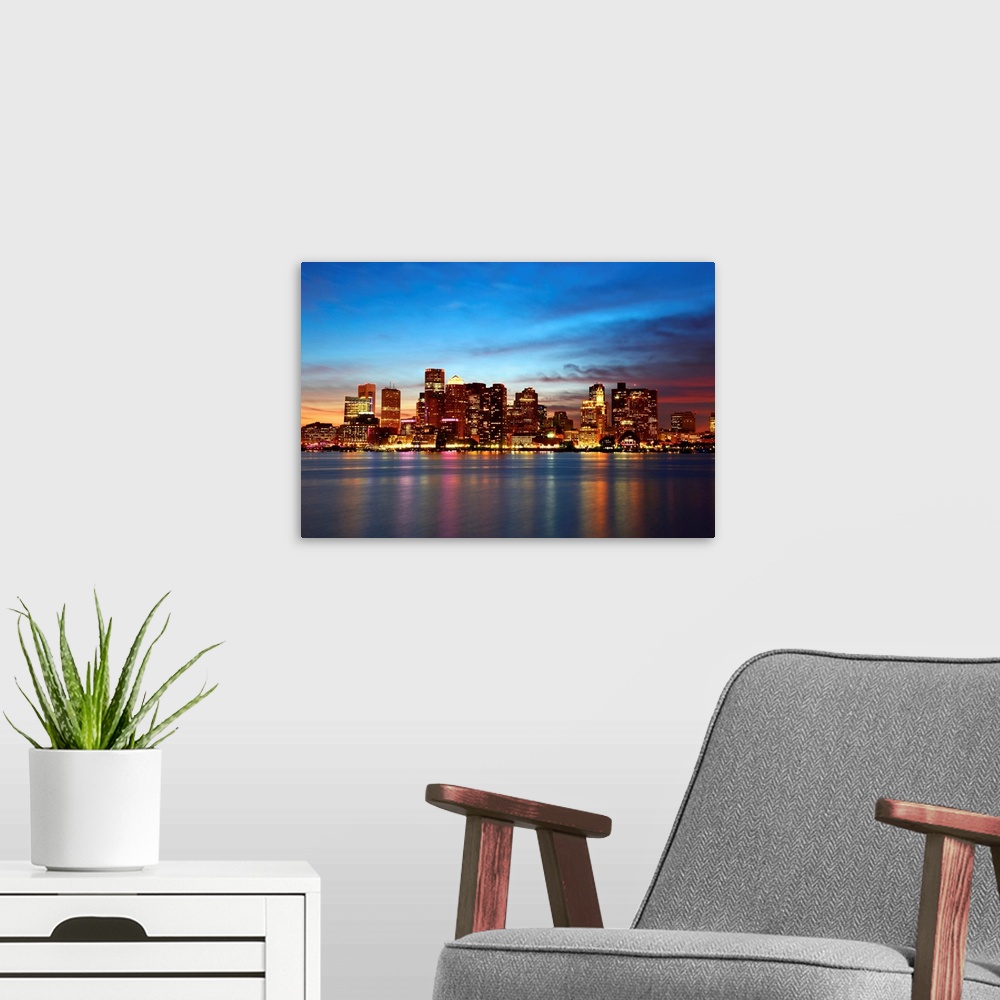 A modern room featuring Boston City Skyscrapers, Custom House and Boston Waterfront at night from East Boston, Boston, Ma...