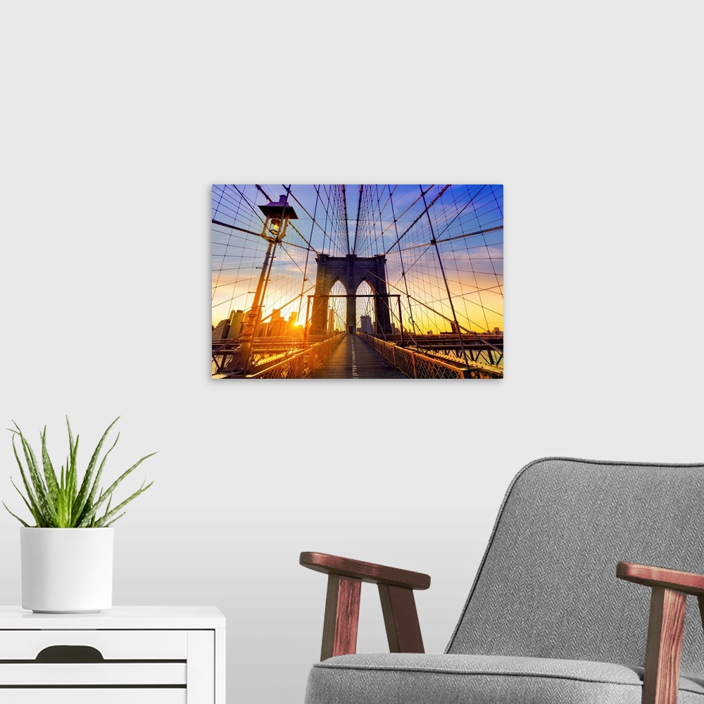 A modern room featuring Brooklyn Bridge at sunset in New York City.