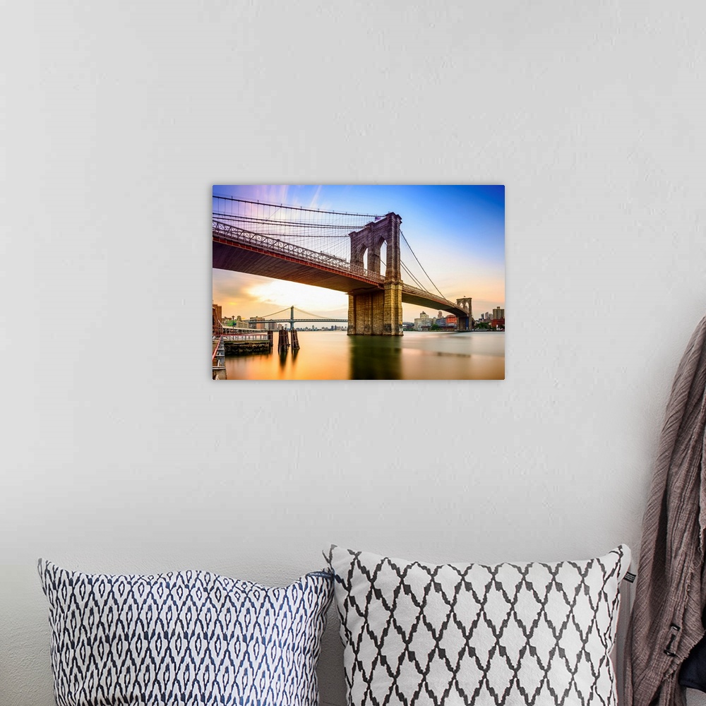 A bohemian room featuring Brooklyn Bridge in New York City at dawn.