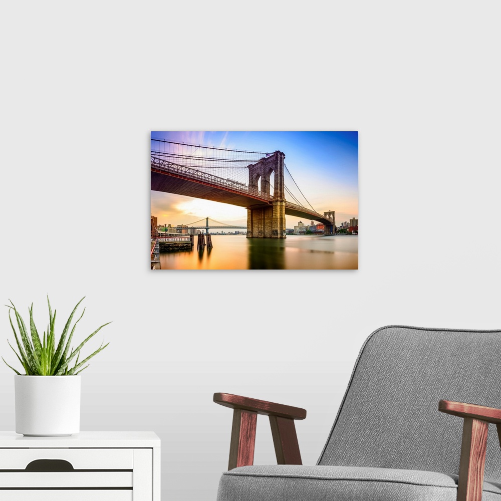 A modern room featuring Brooklyn Bridge in New York City at dawn.