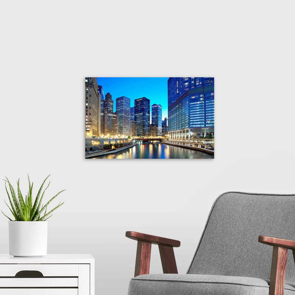 A modern room featuring Chicago skyline along the river just after sunset.