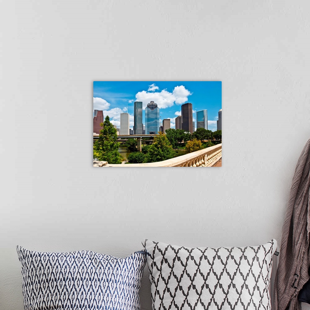 A bohemian room featuring a crisp cityscape of the downtown Houston Texas skyline on a nice summer day