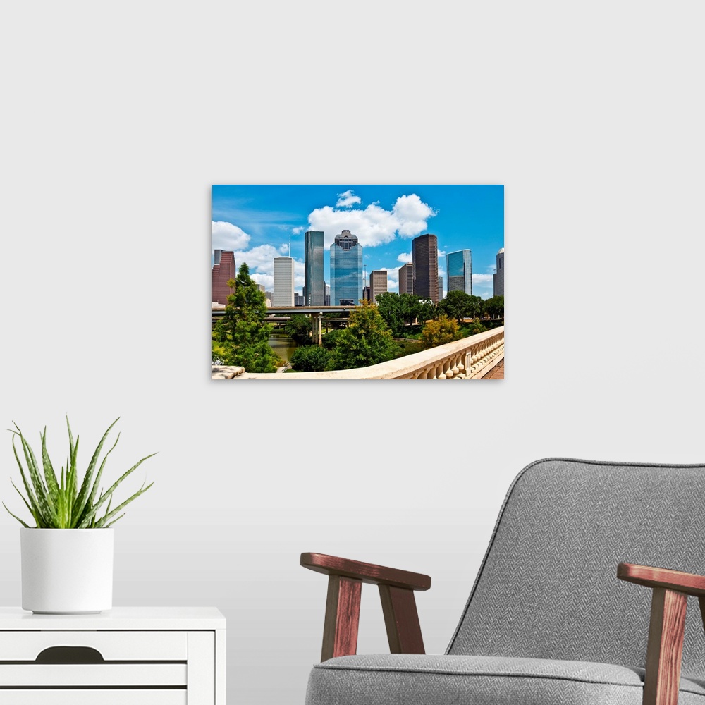 A modern room featuring a crisp cityscape of the downtown Houston Texas skyline on a nice summer day