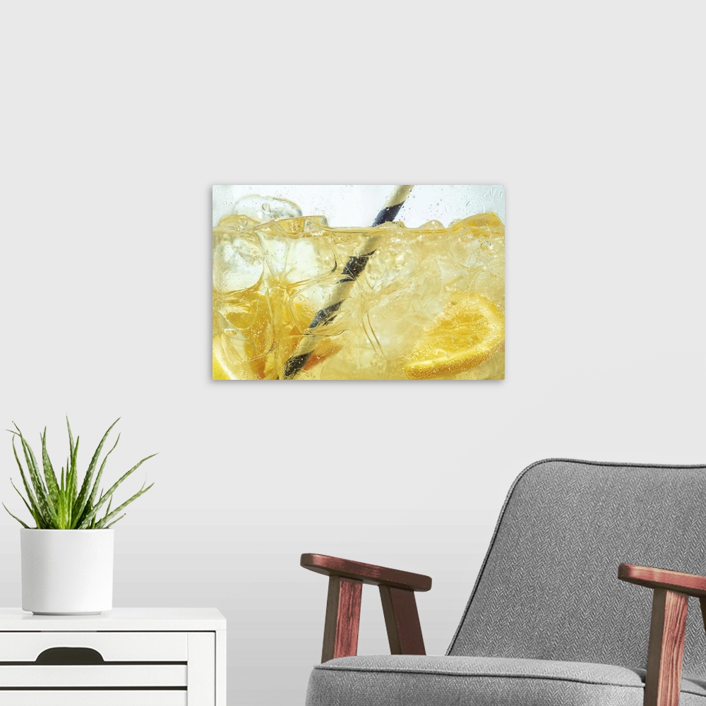 A modern room featuring Close up of lemon slices in stirring the lemonade and ice cubes on background. Texture of cooling...
