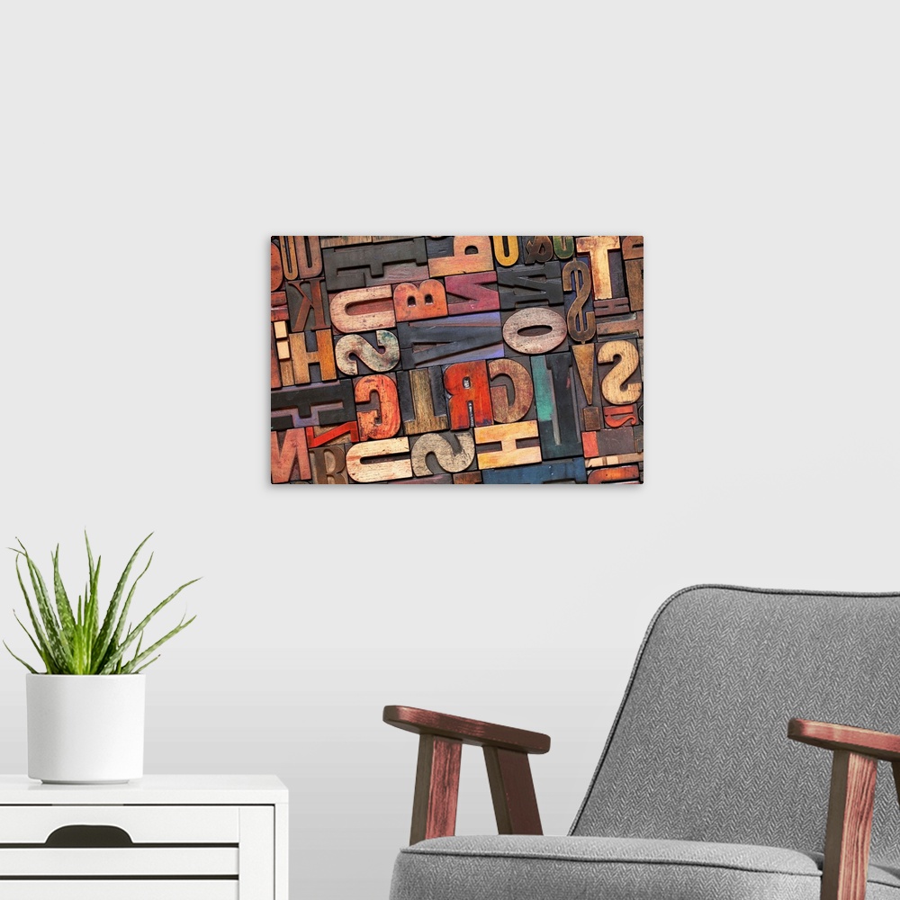 A modern room featuring antique letterpress printing blocks with color ink patina, random collection of different size and s