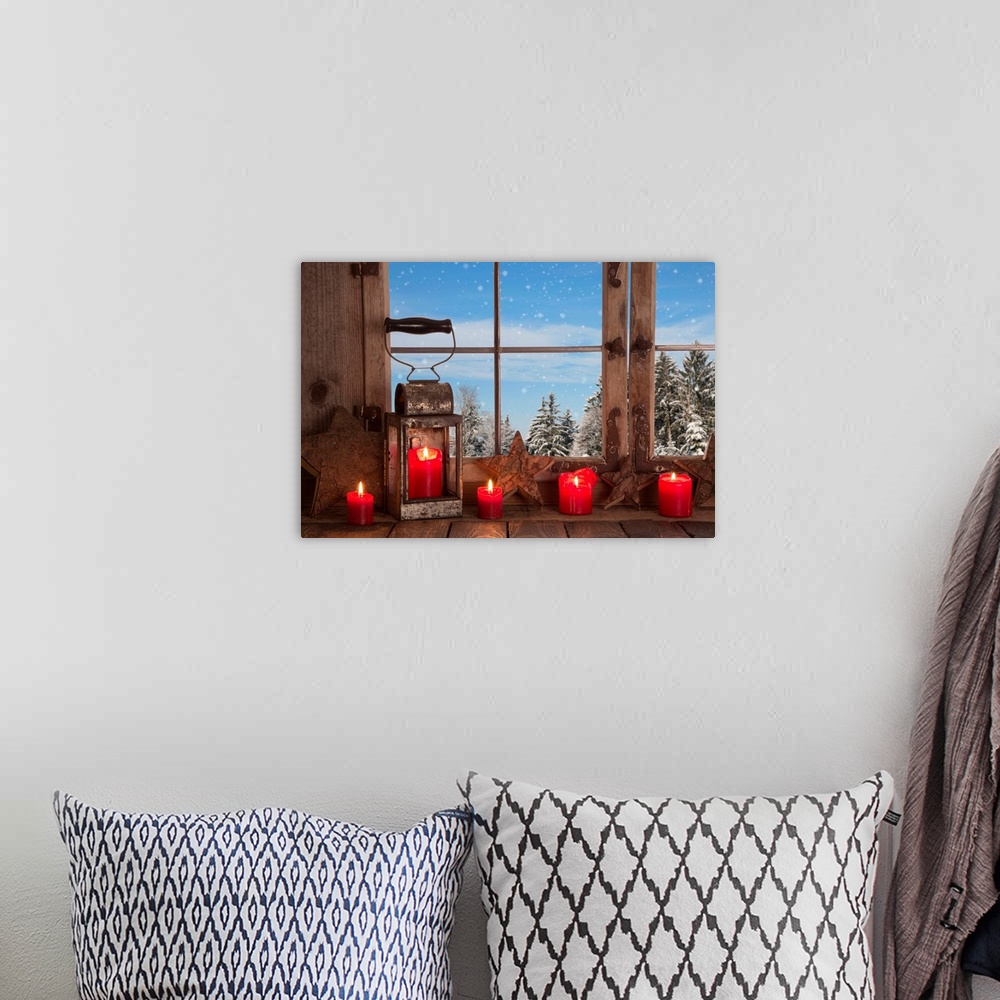 A bohemian room featuring Country Christmas decoration: wooden window decorated with red candles and lantern.