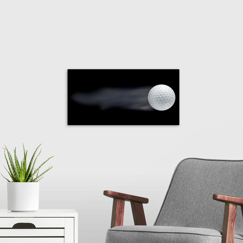 A modern room featuring Golf ball leaving trails behind on black background