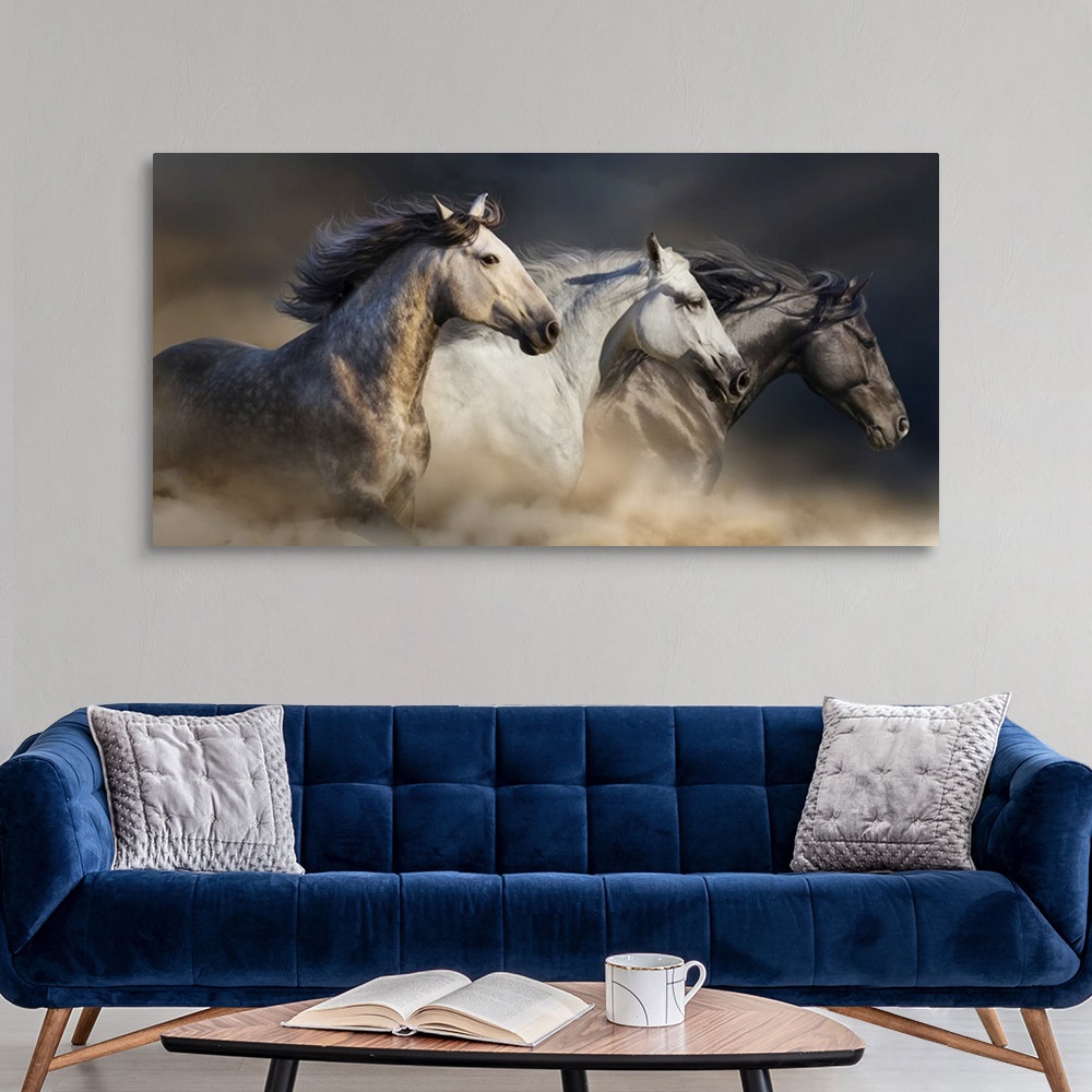 A modern room featuring Portrait of horses with long manes galloping in desert dust.