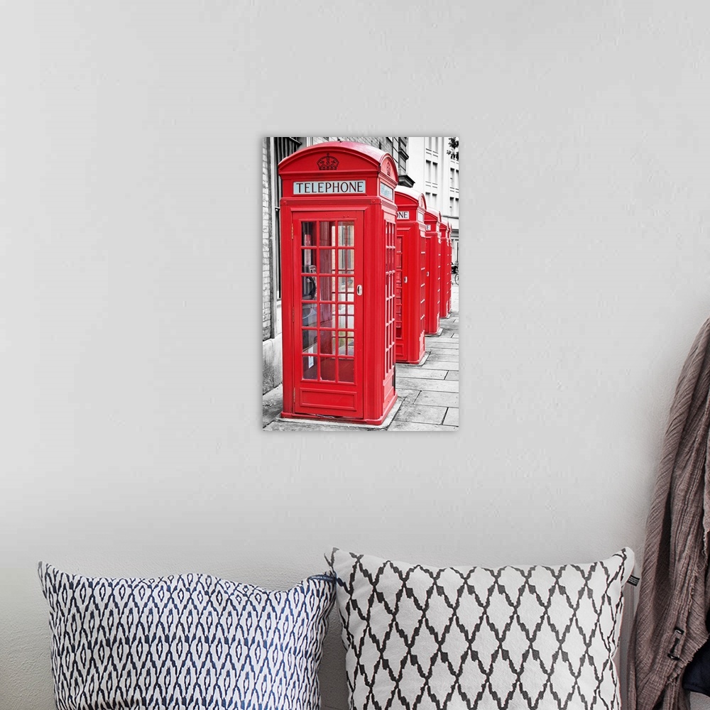 A bohemian room featuring Row of iconic London red phone cabins with the rest of the picture in black and white