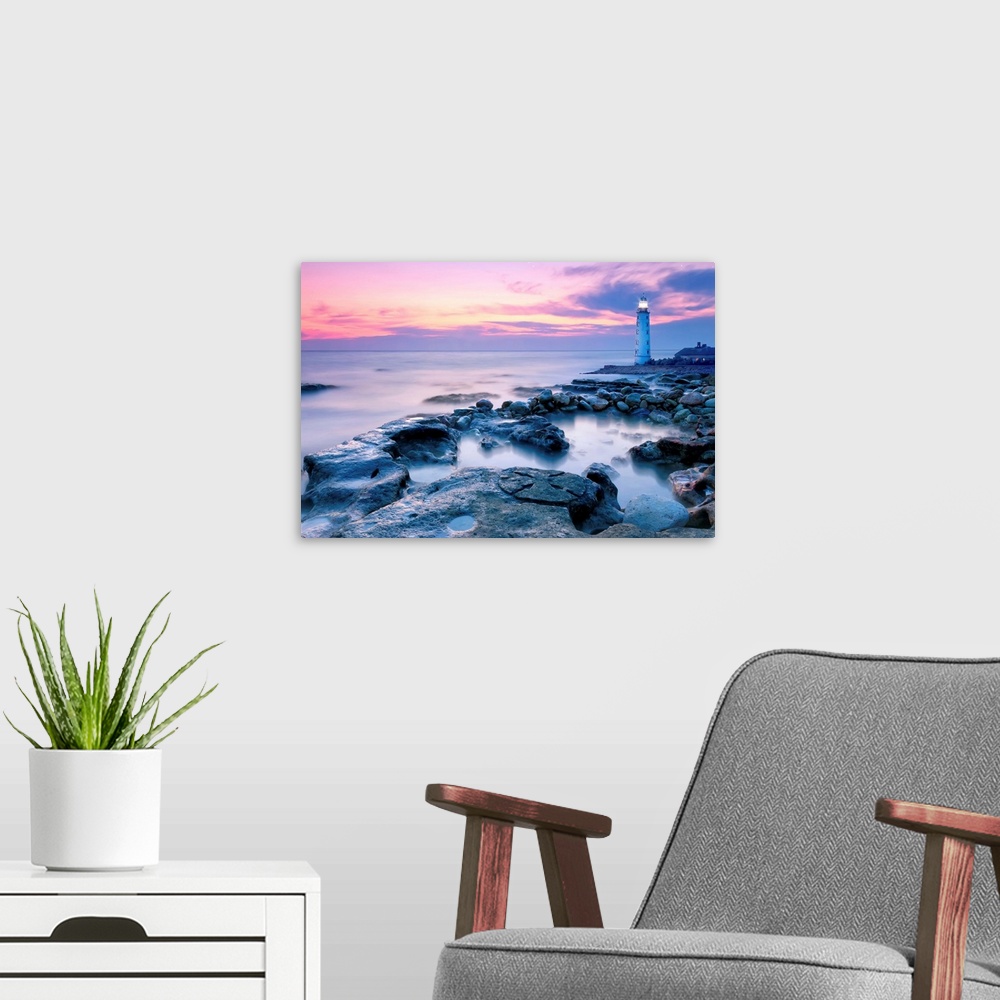 A modern room featuring Lighthouse On Rocky Coastline At Sunset.