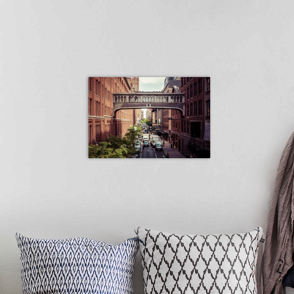 A bohemian room featuring A photograph showing a covered connector between two buildings in New York City with busy trucks ...