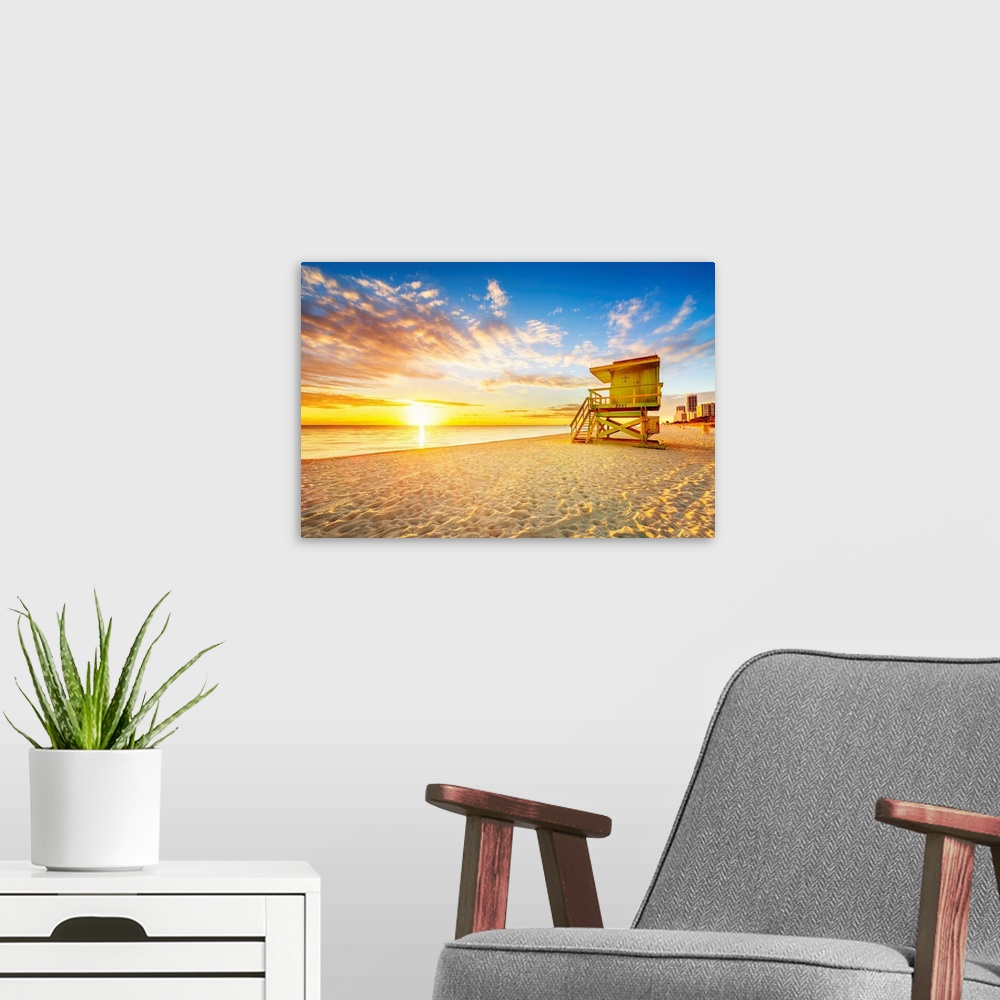 A modern room featuring Miami South Beach sunrise with lifeguard tower and coastline.