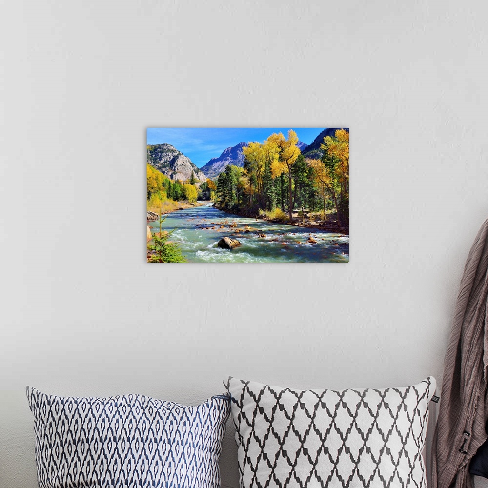 A bohemian room featuring mountain river and colorful mountains of Colorado.