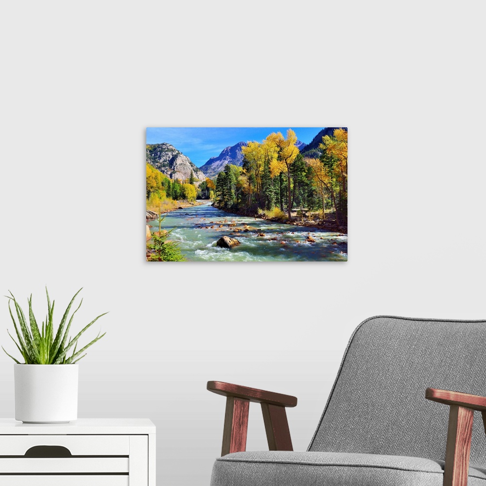 A modern room featuring mountain river and colorful mountains of Colorado.