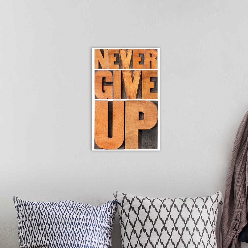 A bohemian room featuring never give up - isolated phrase in vintage letterpress wood type, scaled to rectangle