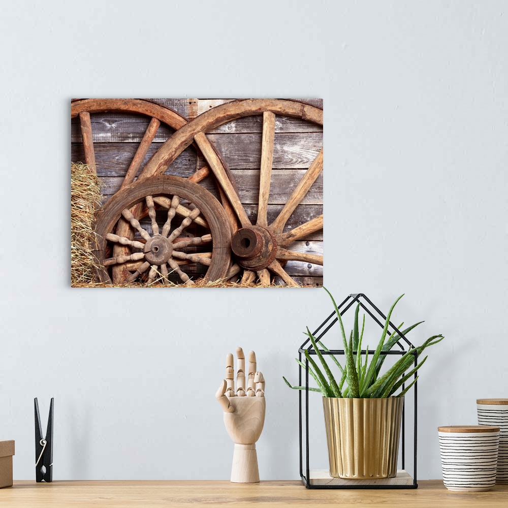 A bohemian room featuring Old wheels from a cart in shed.