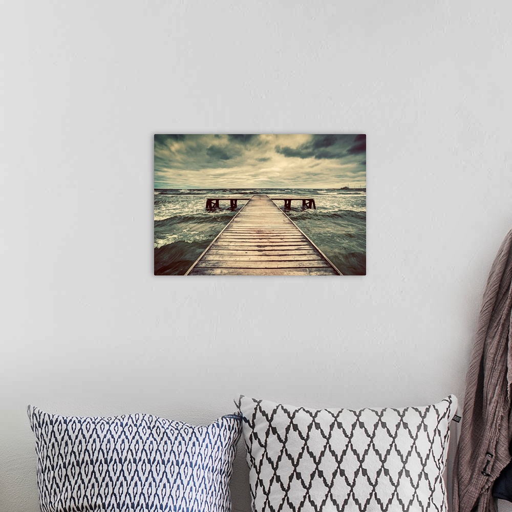 A bohemian room featuring Old wooden jetty, pier, during storm on the sea. Dramatic sky with dark, heavy clouds.