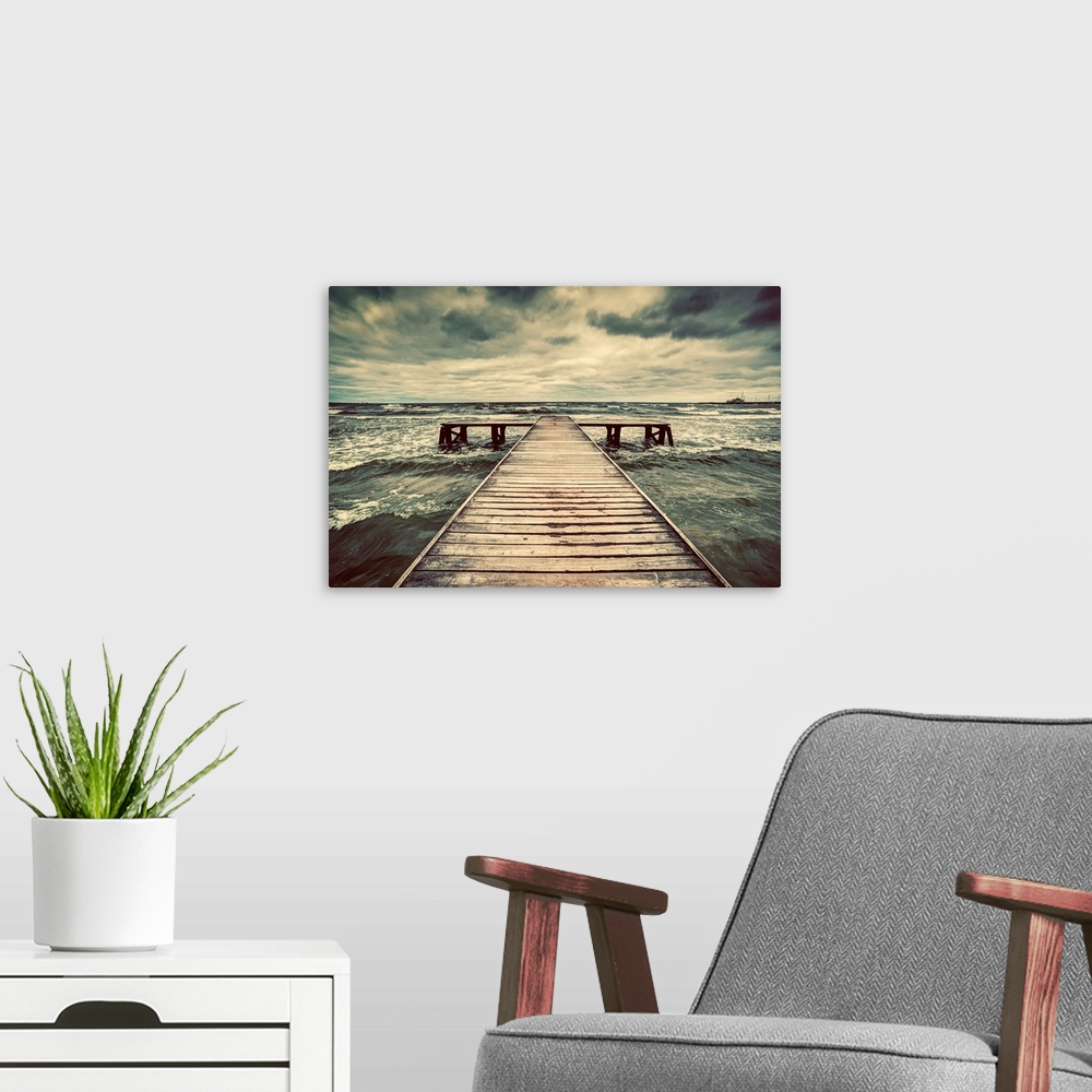 A modern room featuring Old wooden jetty, pier, during storm on the sea. Dramatic sky with dark, heavy clouds.