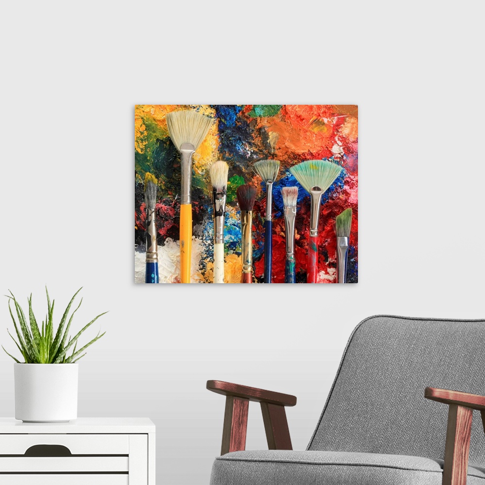 A modern room featuring Artist brushes on an oil painting background.