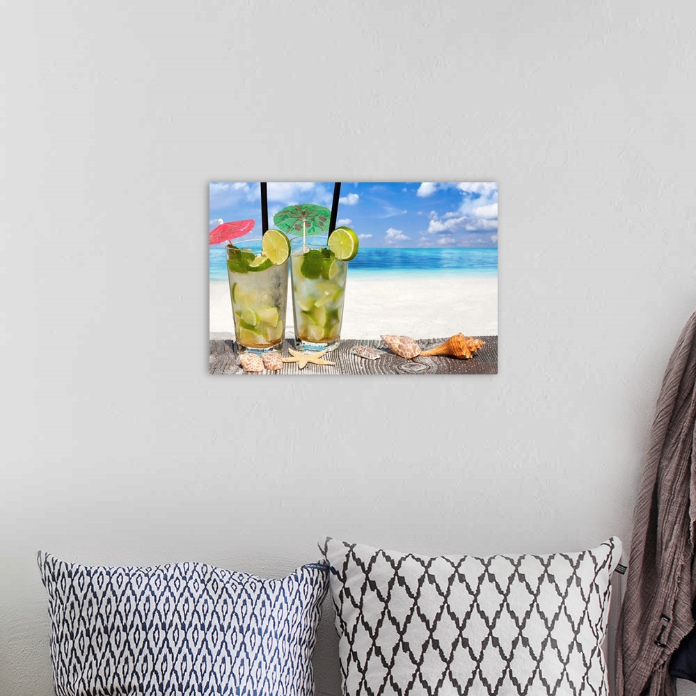 A bohemian room featuring Refreshing Cocktail on Wooden Boards with Starfish and Sea Shell on the Beach.
