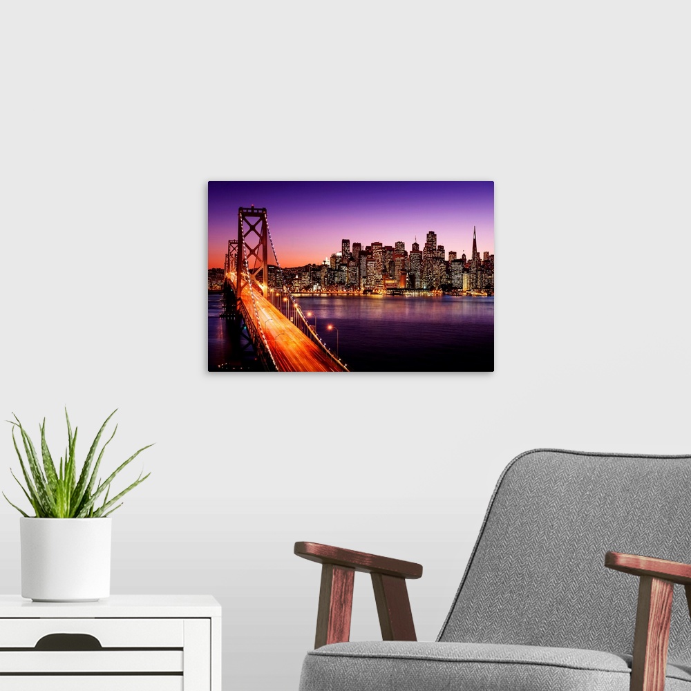 A modern room featuring San Francisco skyline and Bay Bridge at sunset, California.