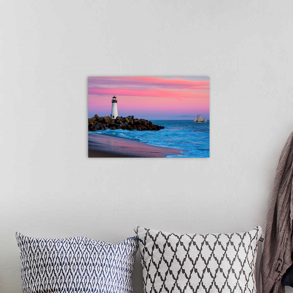 A bohemian room featuring Santa Cruz Breakwater Lighthouse in Santa Cruz, California at sunset.