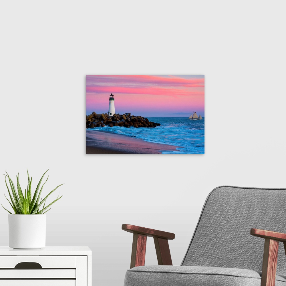 A modern room featuring Santa Cruz Breakwater Lighthouse in Santa Cruz, California at sunset.