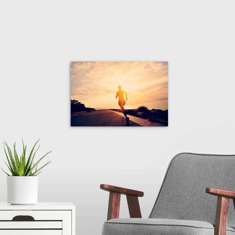 A modern room featuring Silhouette of a runner at seaside.