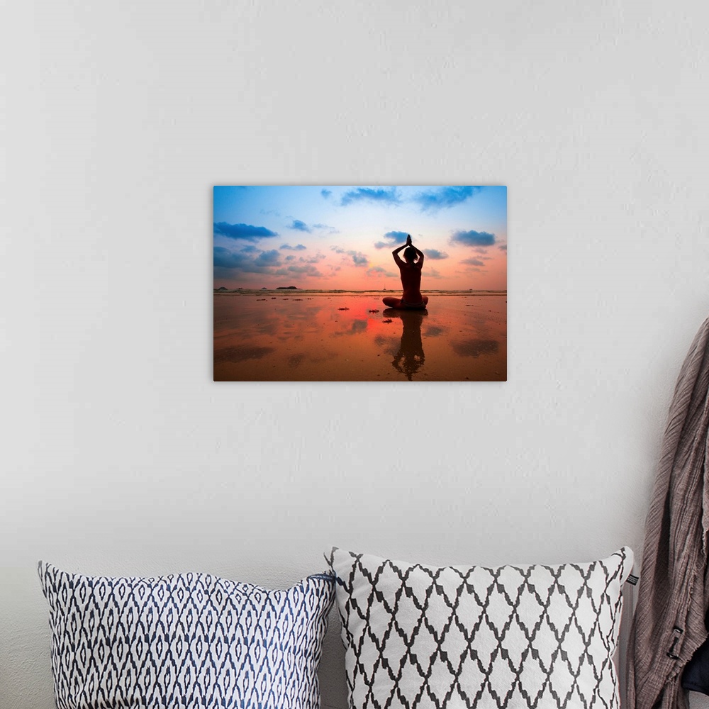 A bohemian room featuring Silhouette of woman practicing yoga on the beach at sunset