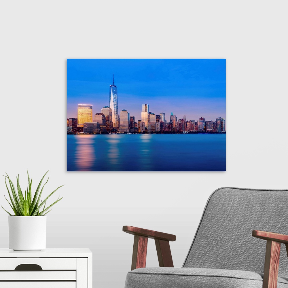 A modern room featuring Skyline of lower Manhattan of New York City at night with new One World Trade Center.