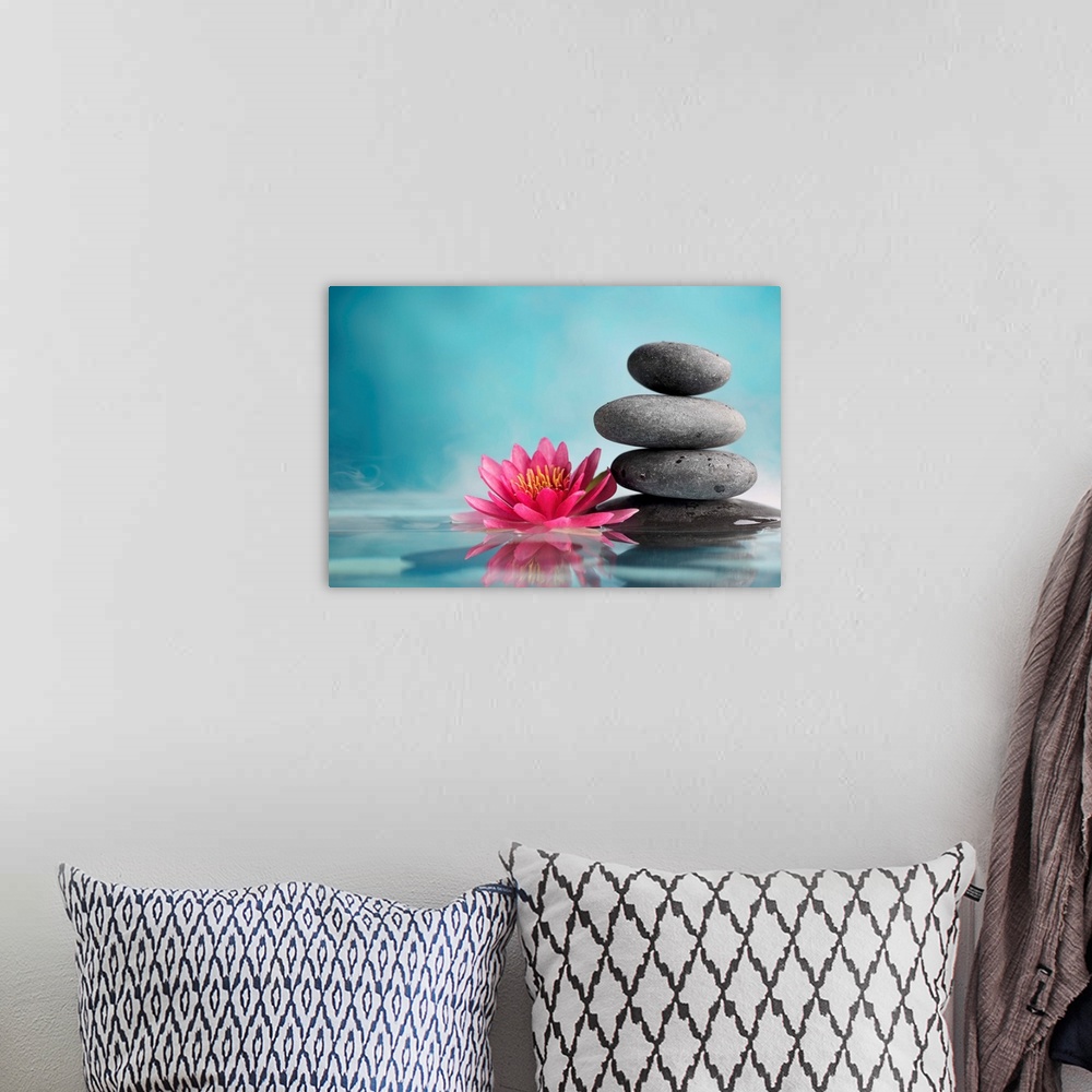 A bohemian room featuring Spa still life with water lily and zen stone in a serenity pool.