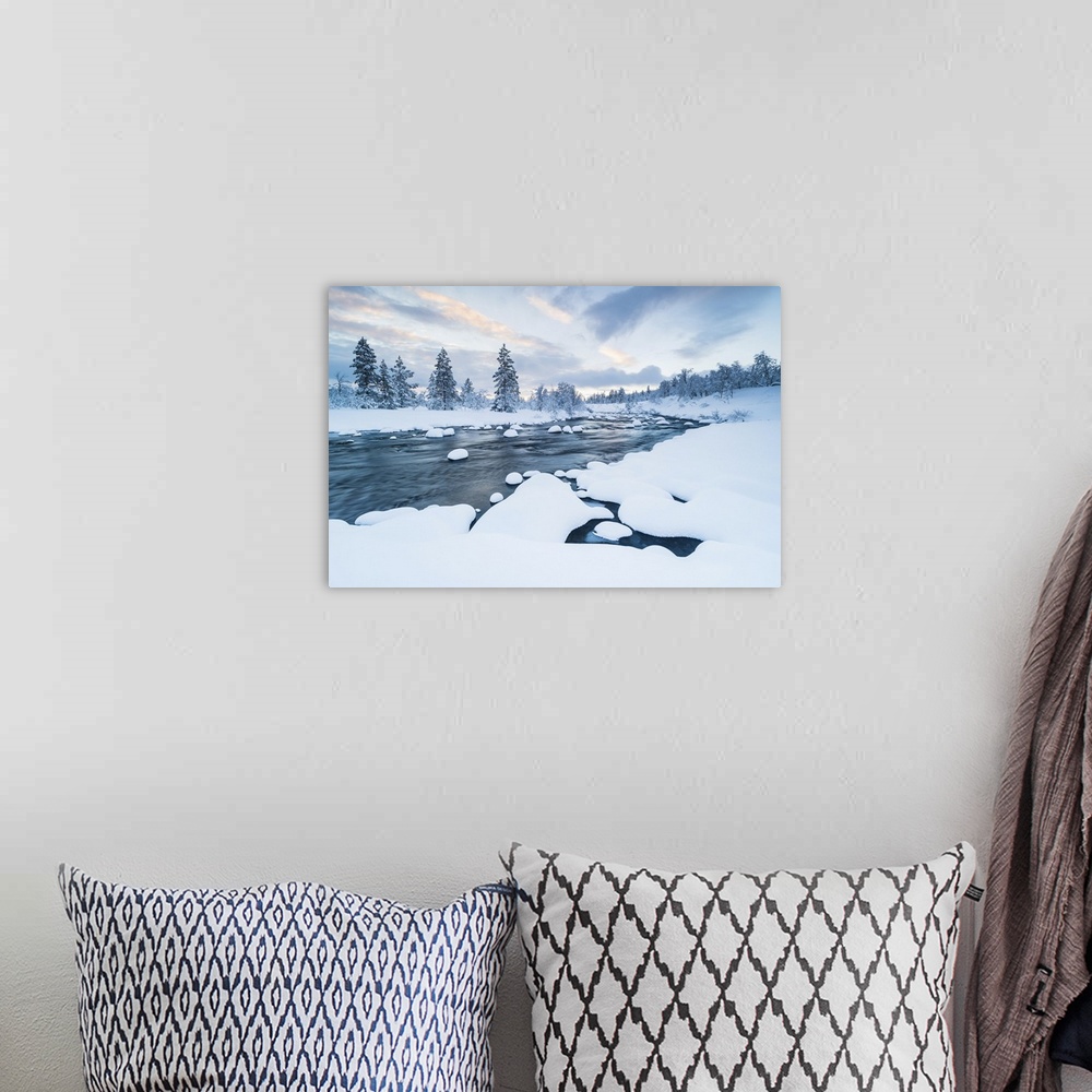 A bohemian room featuring The river with snow in it and a forest near covered with snow in winter in Sweden.