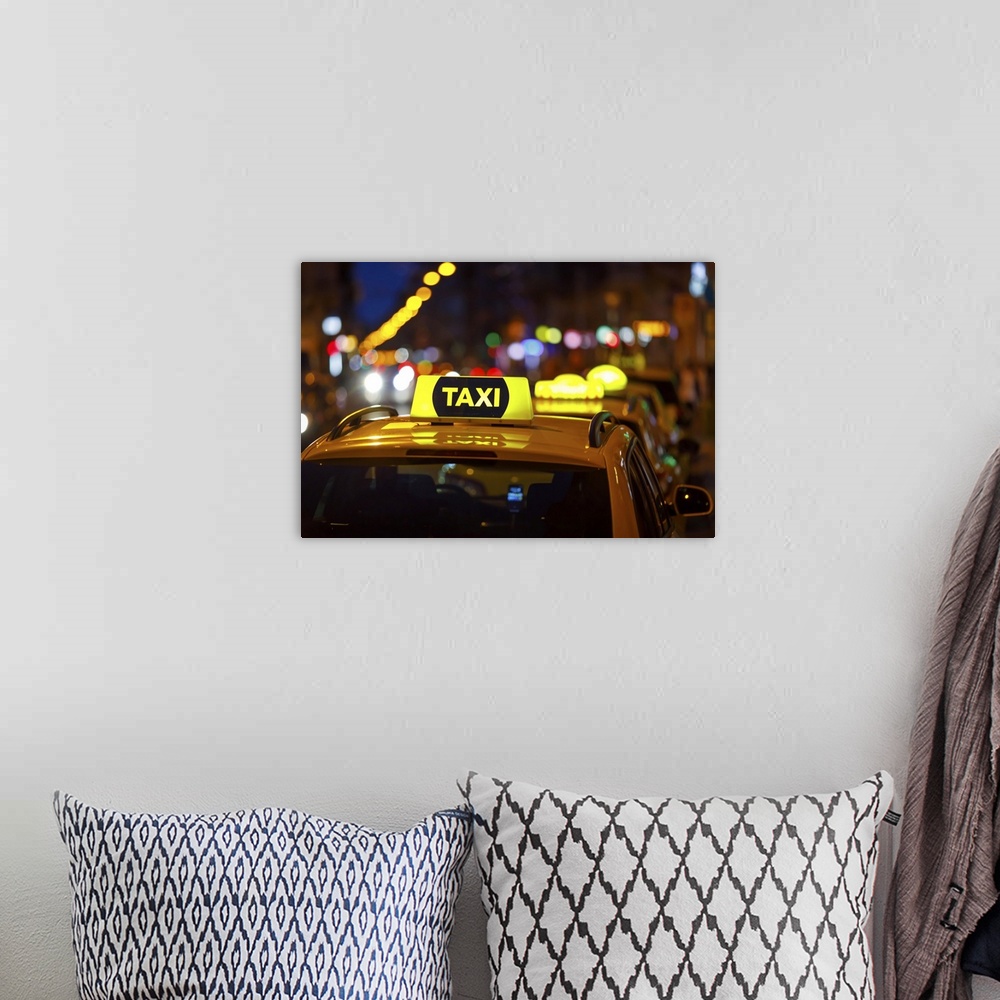 A bohemian room featuring Taxi And Blurred City Lights At Night