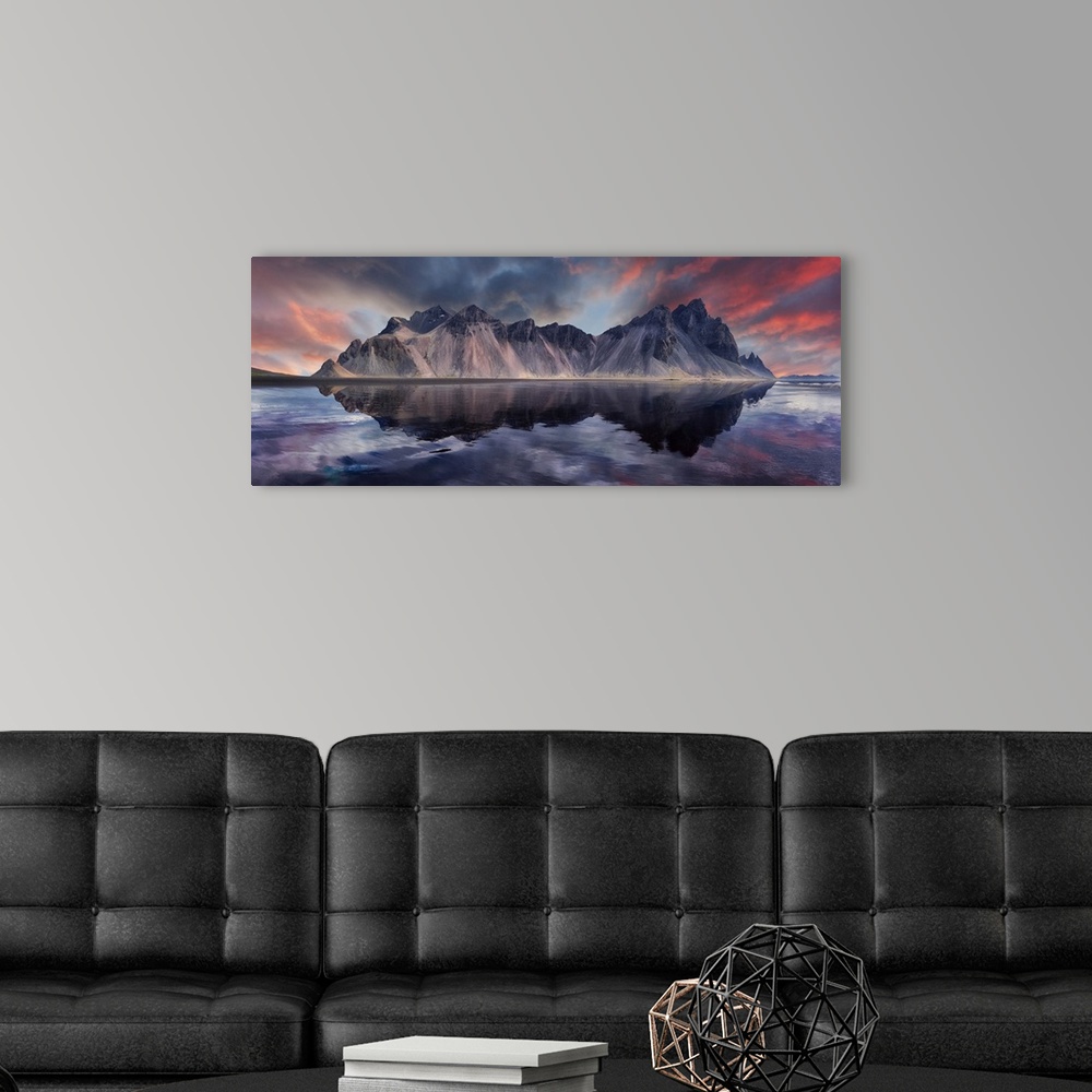 A modern room featuring Vestrahorn mountain on Stokksnes cape in Iceland during sunset with reflections.
