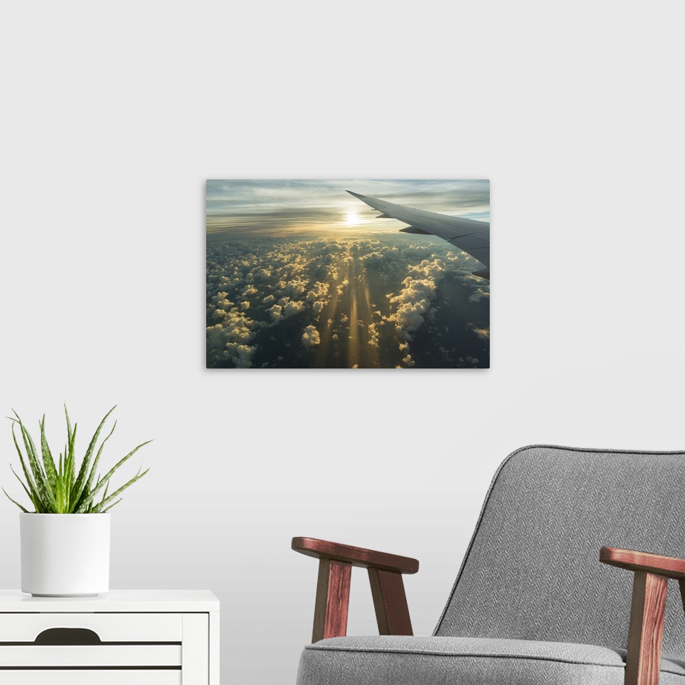 A modern room featuring View From Airplane Side Window Of Sunset Sky And Sunlit Clouds