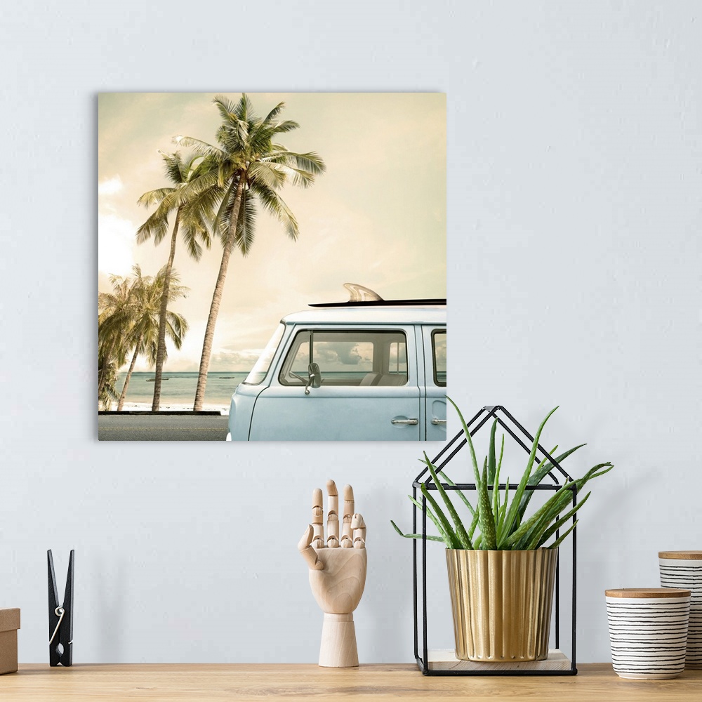 A bohemian room featuring Vintage car parked on a tropical beach with a surfboard on the roof.