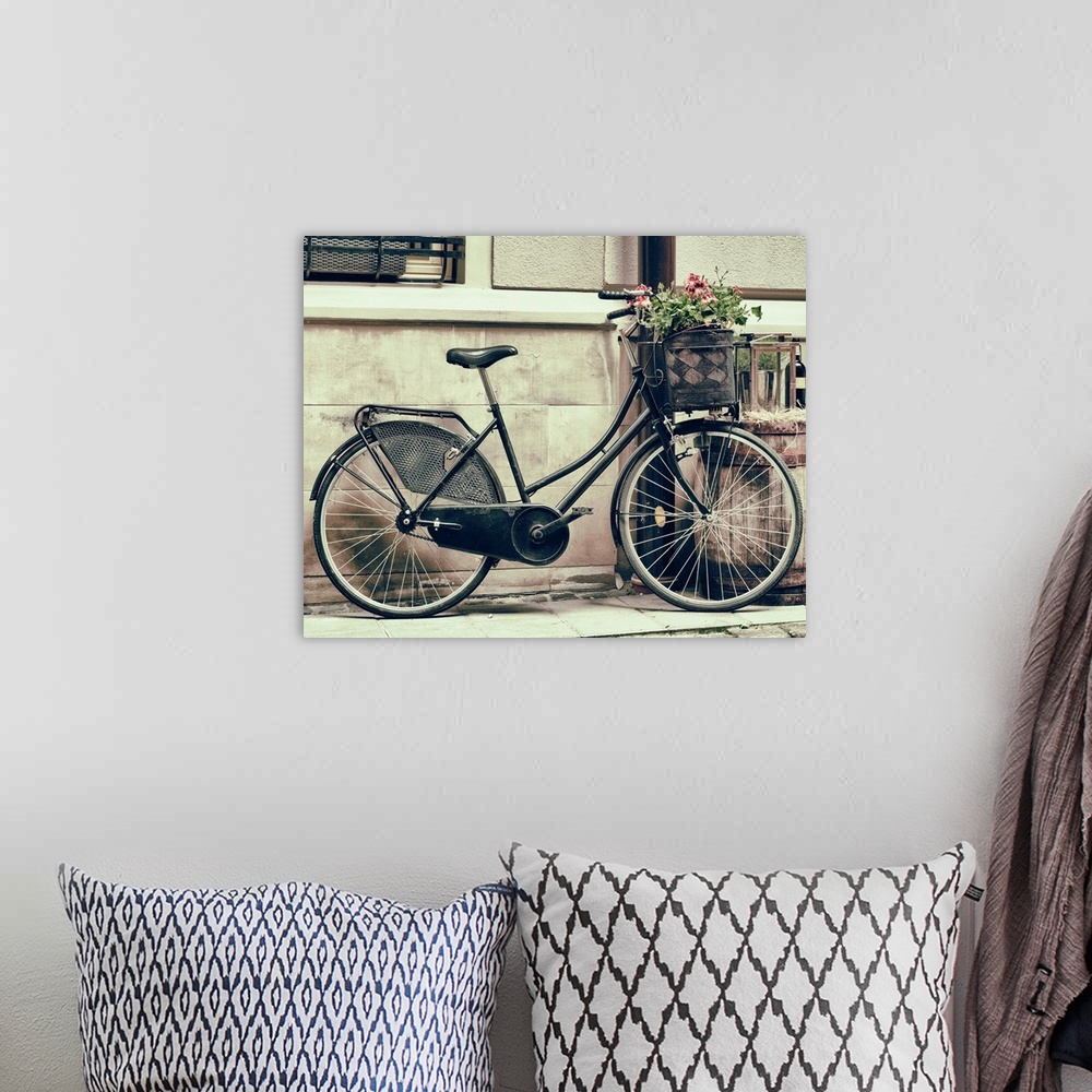 A bohemian room featuring Vintage stylized photo of Old bicycle carrying flowers as decoration.