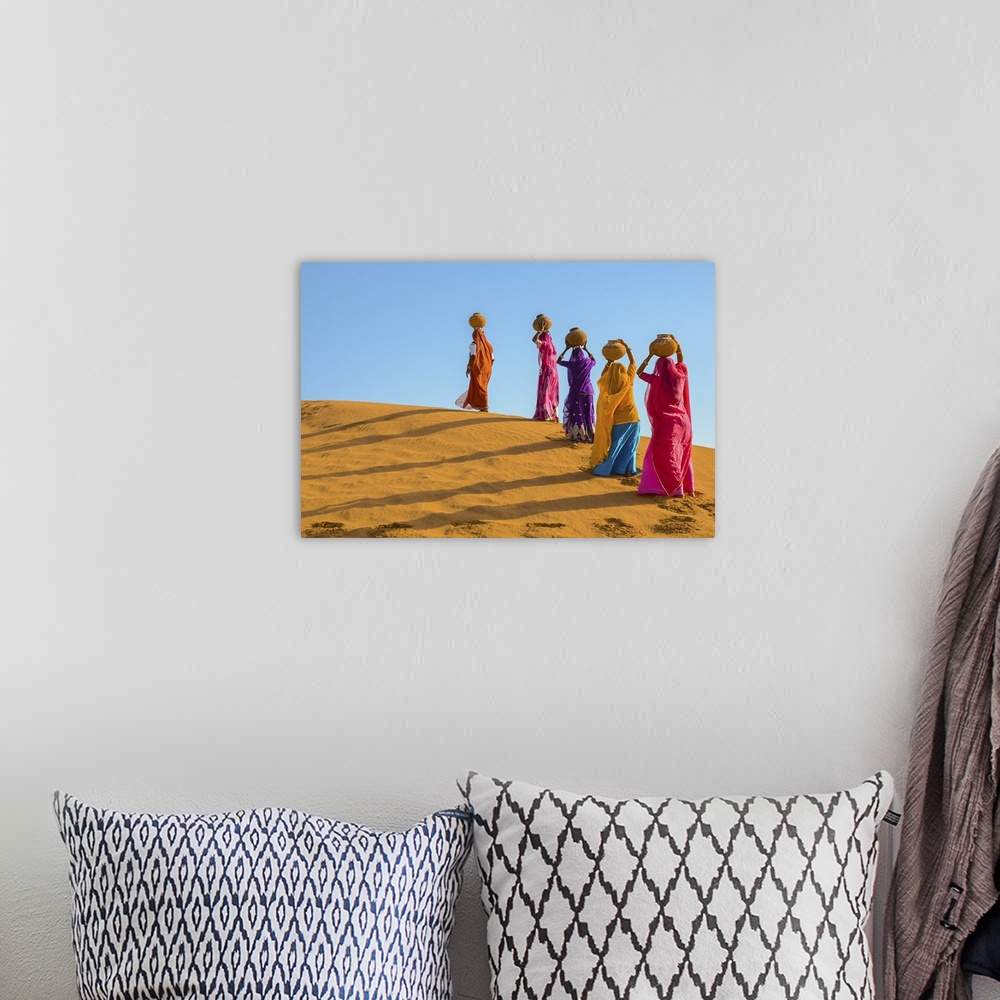 A bohemian room featuring Women Carrying Jugs Of Water In The Hot Summer Desert